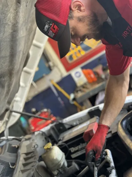 Josh Bailey, owner and lead mechanic at Dirty Dawgs Garage, working on engine repair in St. Augustine FL